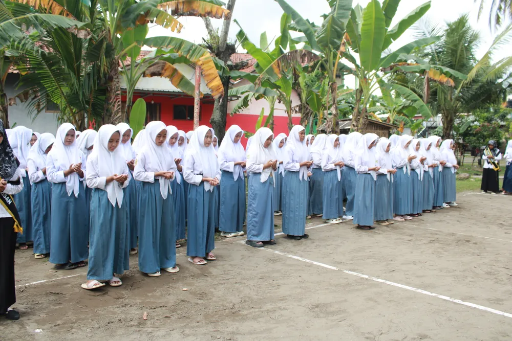 Barisan siswi yang khusyuk mengikuti upacara Hari Guru Nasional